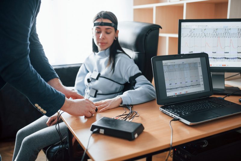 Trying not to worry. Girl passes lie detector in the office. Asking questions. Polygraph test